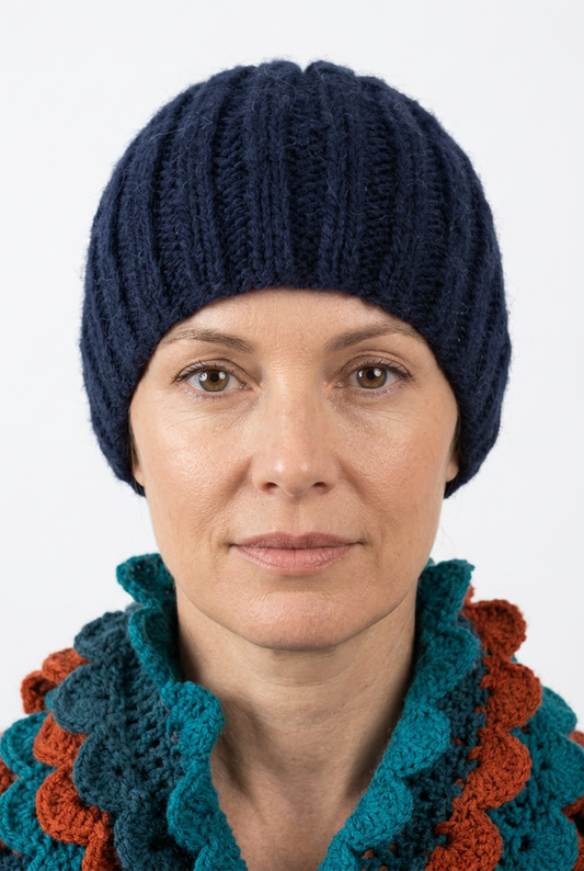 Navy blue hand-knitted hat on a natural-looking model, front view