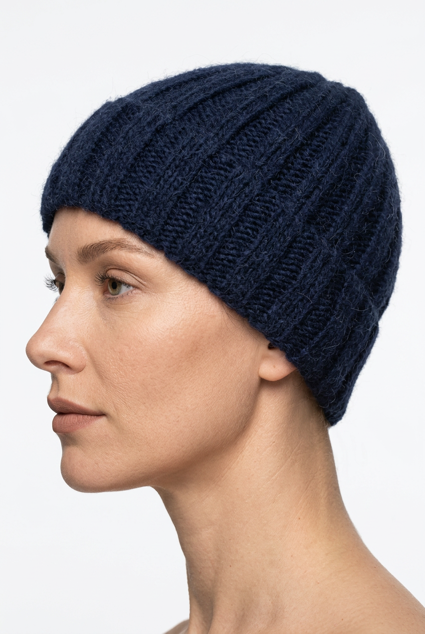 Navy blue hand-knitted hat on a natural-looking model, side view